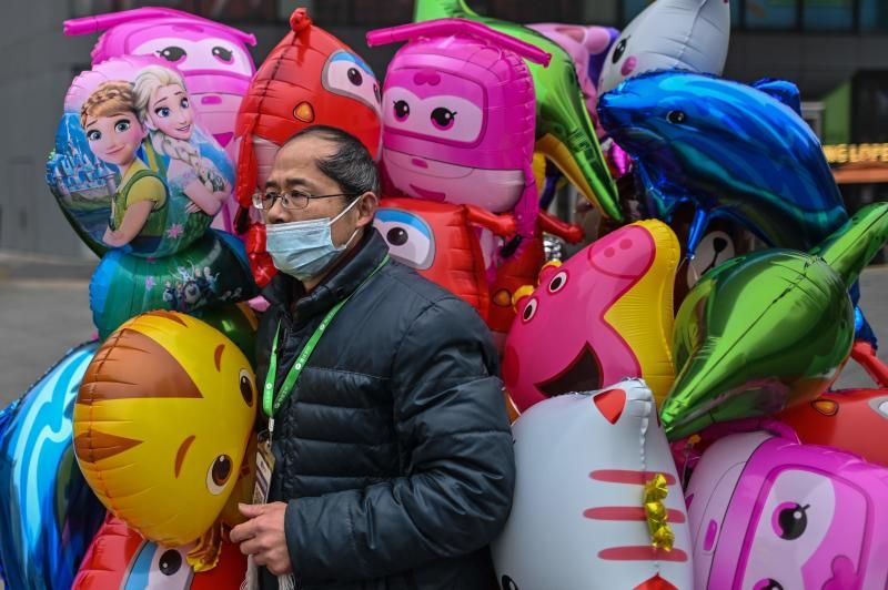 Wuhan marks a year since lockdown as Biden warns of 600,000 dead