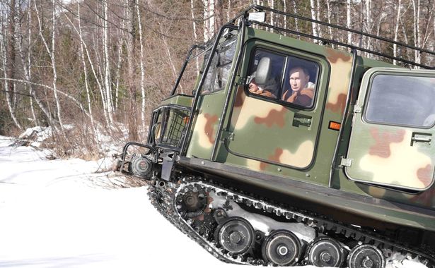 Vladimir Putin drives tank across frozen river dressed in sheepskin in bizarre photos