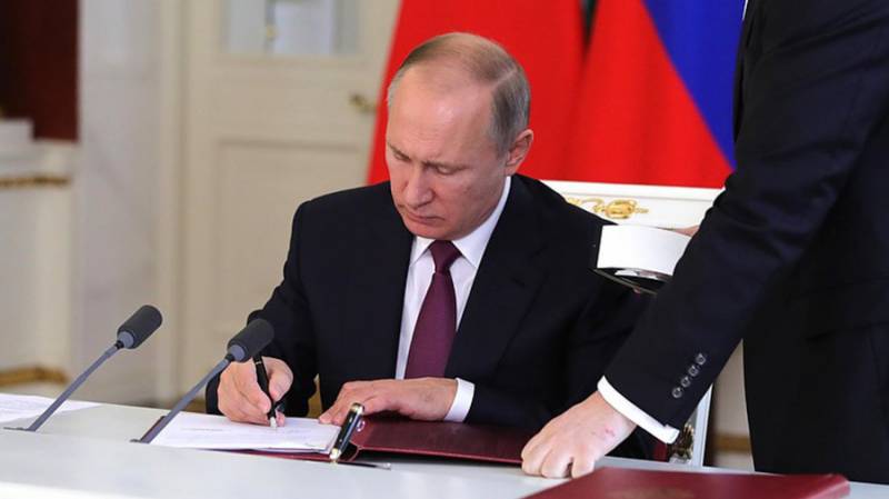 Putin signs law allowing him to serve two more terms