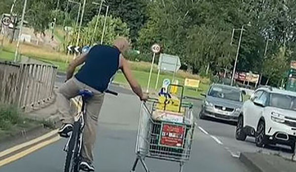 Cyclist filmed towing full shopping trolley