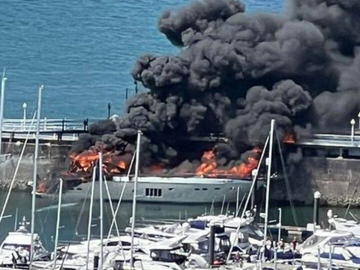 After a major fire, a superyacht sinks in Torquay Harbour.
