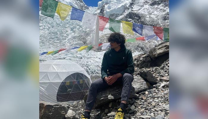 A young Pakistani climber stretch to Mount Everest base camp.