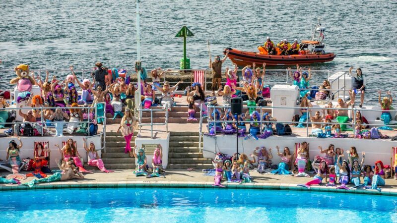 Nearly 400 Britons break the world record for the most mermaids ever gathered in one place.
